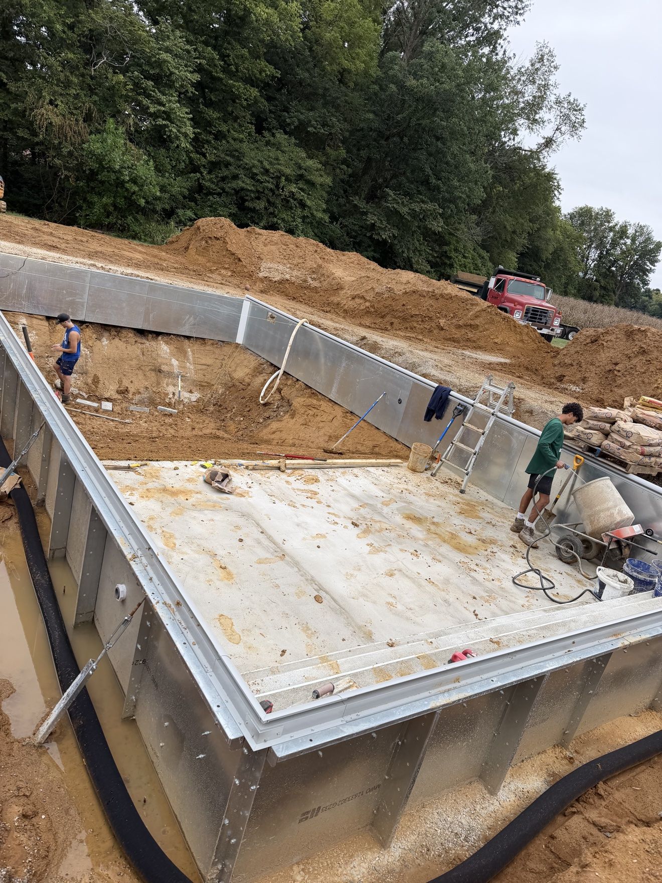 Inground pool with steel walls set while the crew shapes the floor