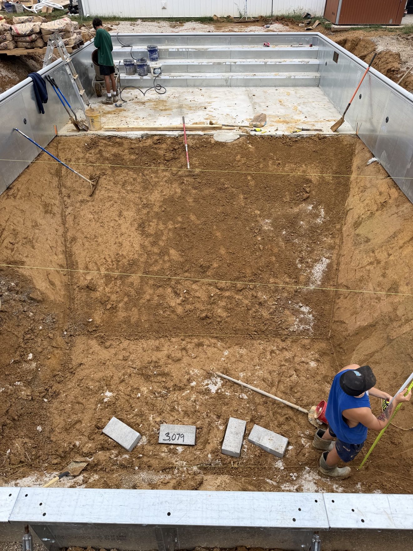 Overhead view of the pool floor layout marked out with string lines